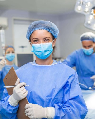 Surgeon writing on clipboard in operation room, anaesthesiologist writing the updates